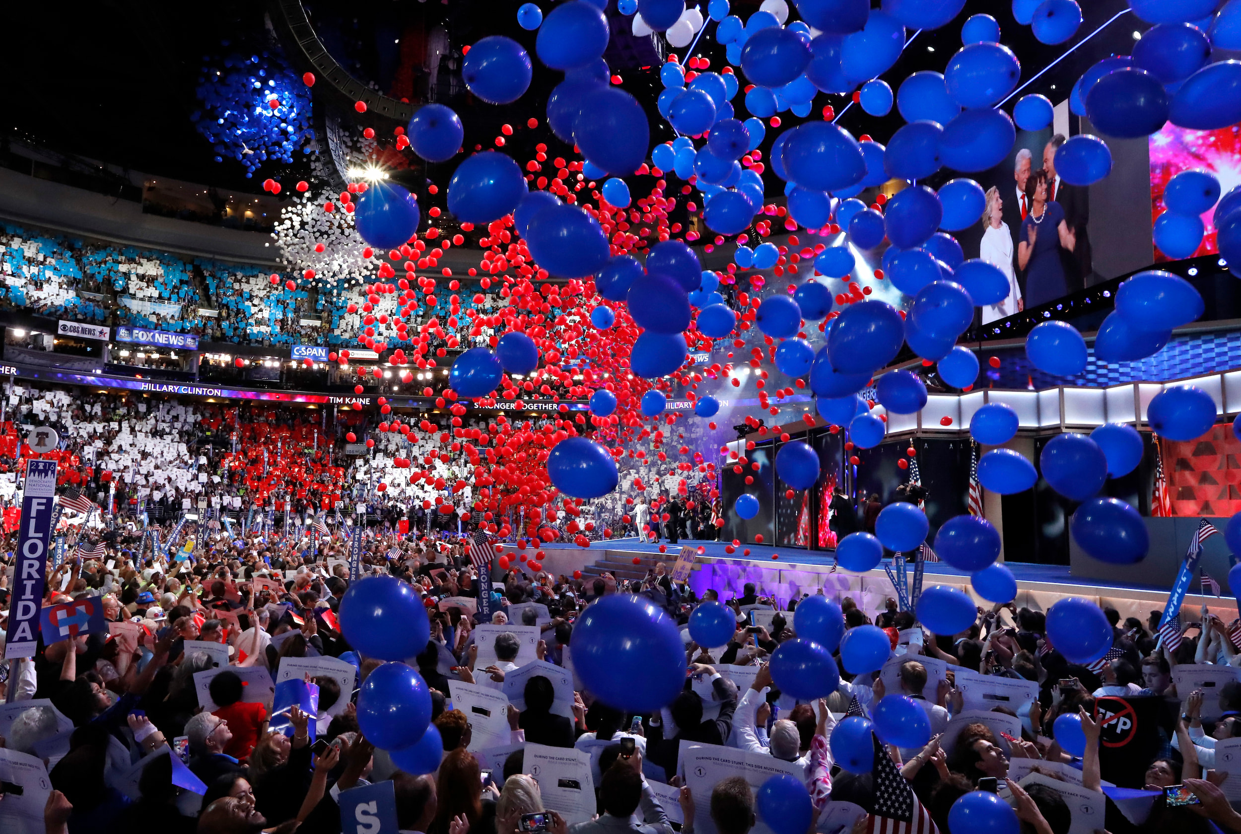 Balloons descend from the ceiling of a large arena onto a crowd of people at the 2016 Democratic National Convention in Philadelphia.