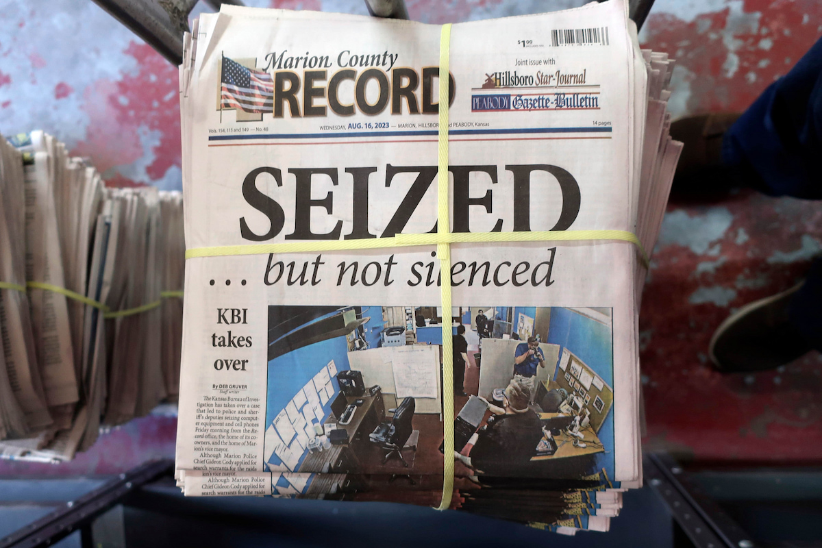 A stack of the Marion County Record sits in the back of the newspaper's building, awaiting unbundling, sorting and distribution, Aug. 16, 2023, in Marion, Kan. (AP Photo/John Hanna, File)