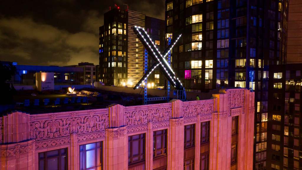 Workers install lighting on an "X" sign atop the company headquarters, formerly known as Twitter, in downtown San Francisco, on Friday, July 28, 2023. San Francisco has launched an investigation into the sign as city officials say replacing letters or symbols on buildings, or erecting a sign on top of one, requires a permit. (AP Photo/Noah Berger)