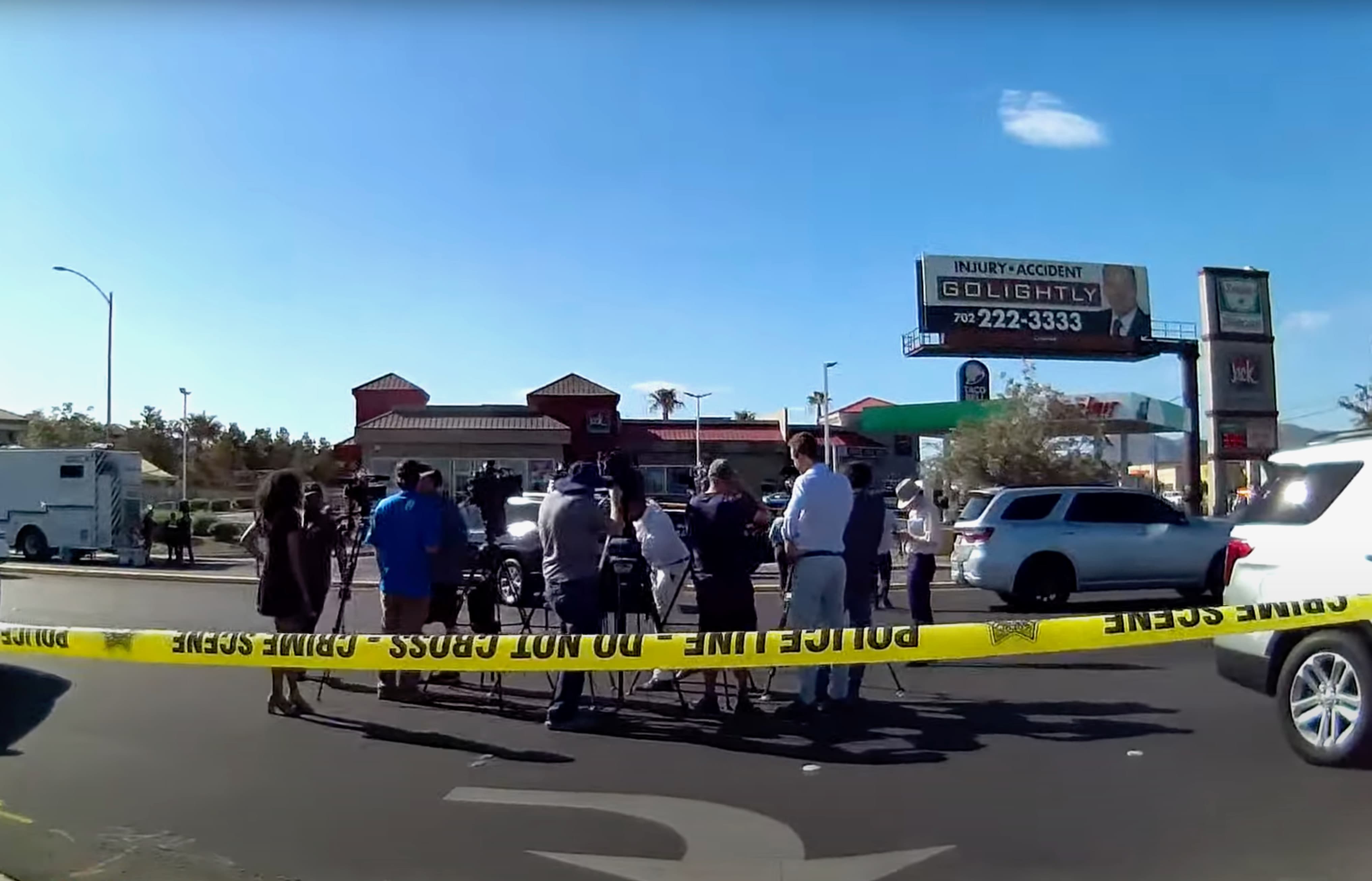 A screengrab taken from a video filmed by Las Vegas Live shows journalists gathered inside police tape for a crime scene briefing after a police official excluded a journalist from the stringer organization.