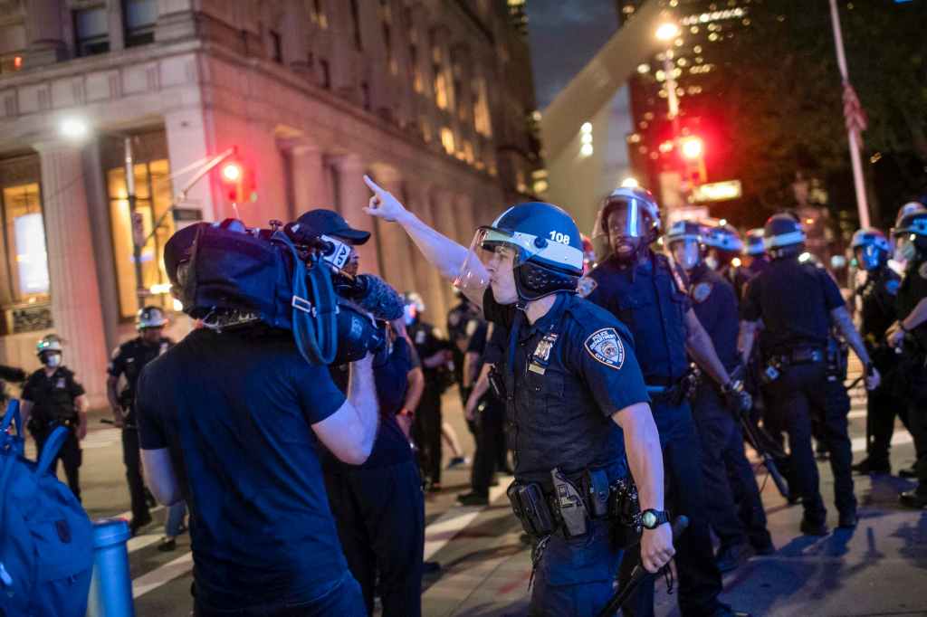 A police officer shouts at Associated Press videojournalist Robert Bumsted, Tuesday, June 2, 2020, in New York. (AP Photo/Wong Maye-E)